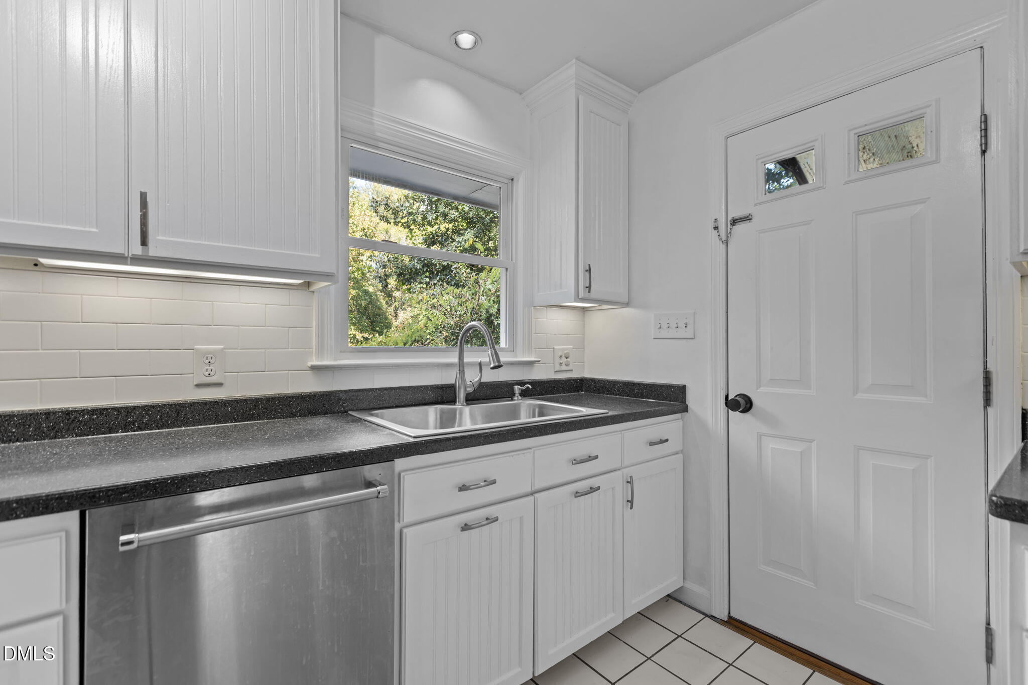 3117 Edgetone Drive Raleigh, NC 27604 - Photo 16 of 50 a kitchen with a sink cabinets and window