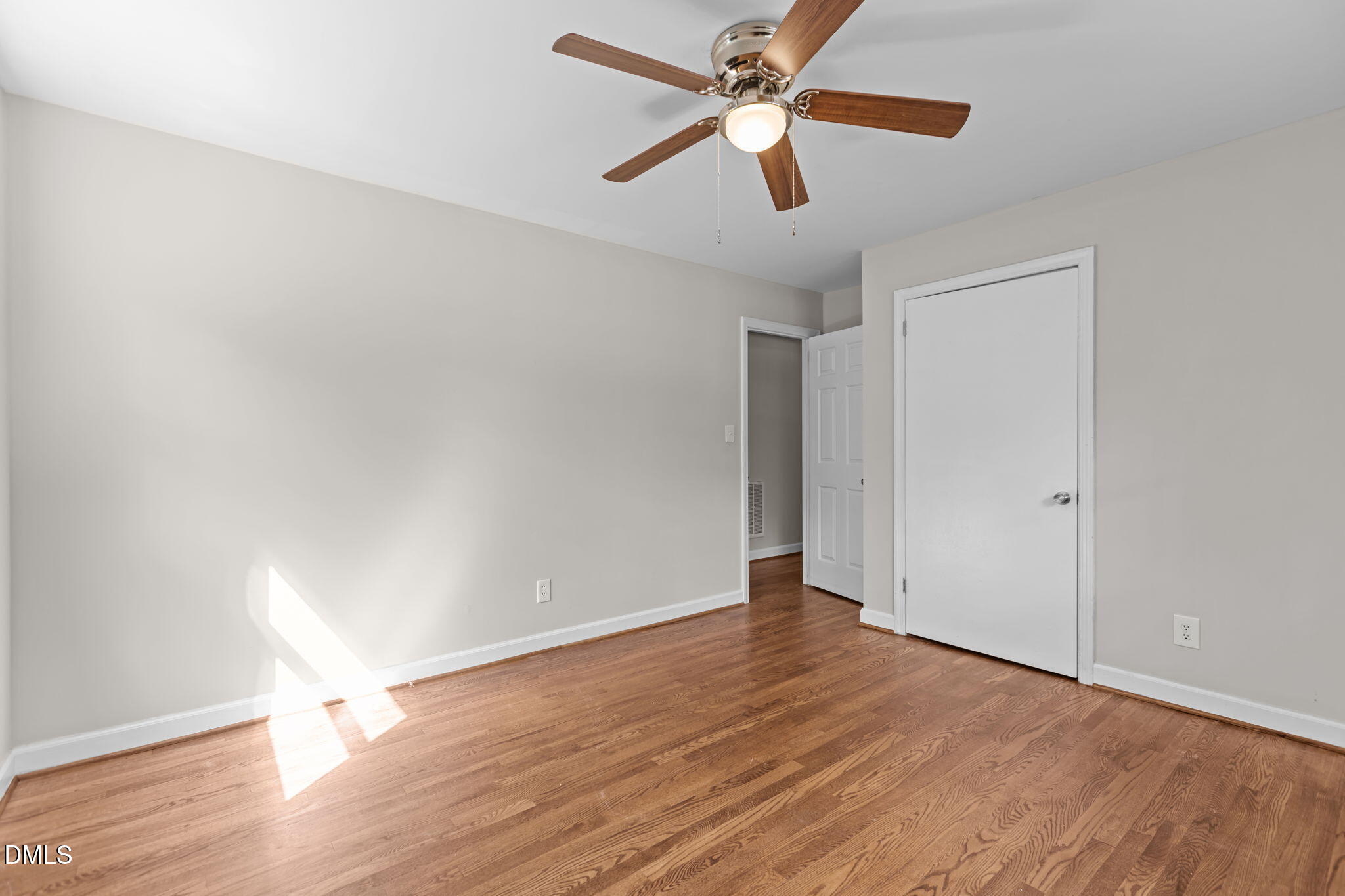 3117 Edgetone Drive Raleigh, NC 27604 - Photo 24 of 50 an empty room with wooden floor and a ceiling fan