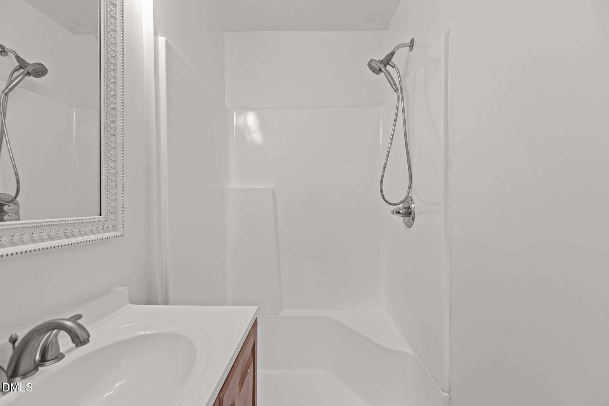 3117 Edgetone Drive Raleigh, NC 27604 - Photo 28 of 50 a bathroom with a sink and a shower