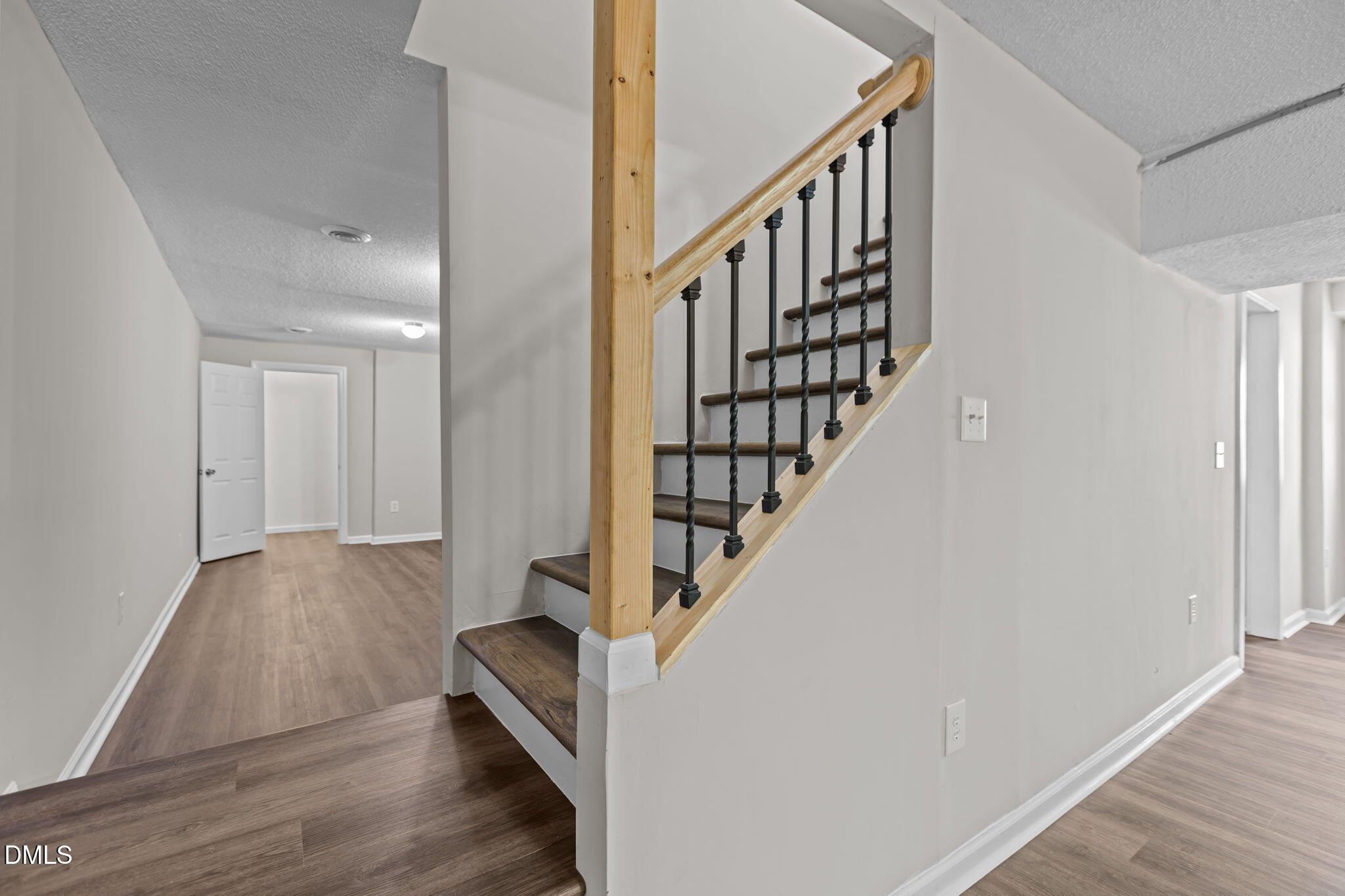 3117 Edgetone Drive Raleigh, NC 27604 - Photo 29 of 50 a view of staircase with wooden floor and white walls