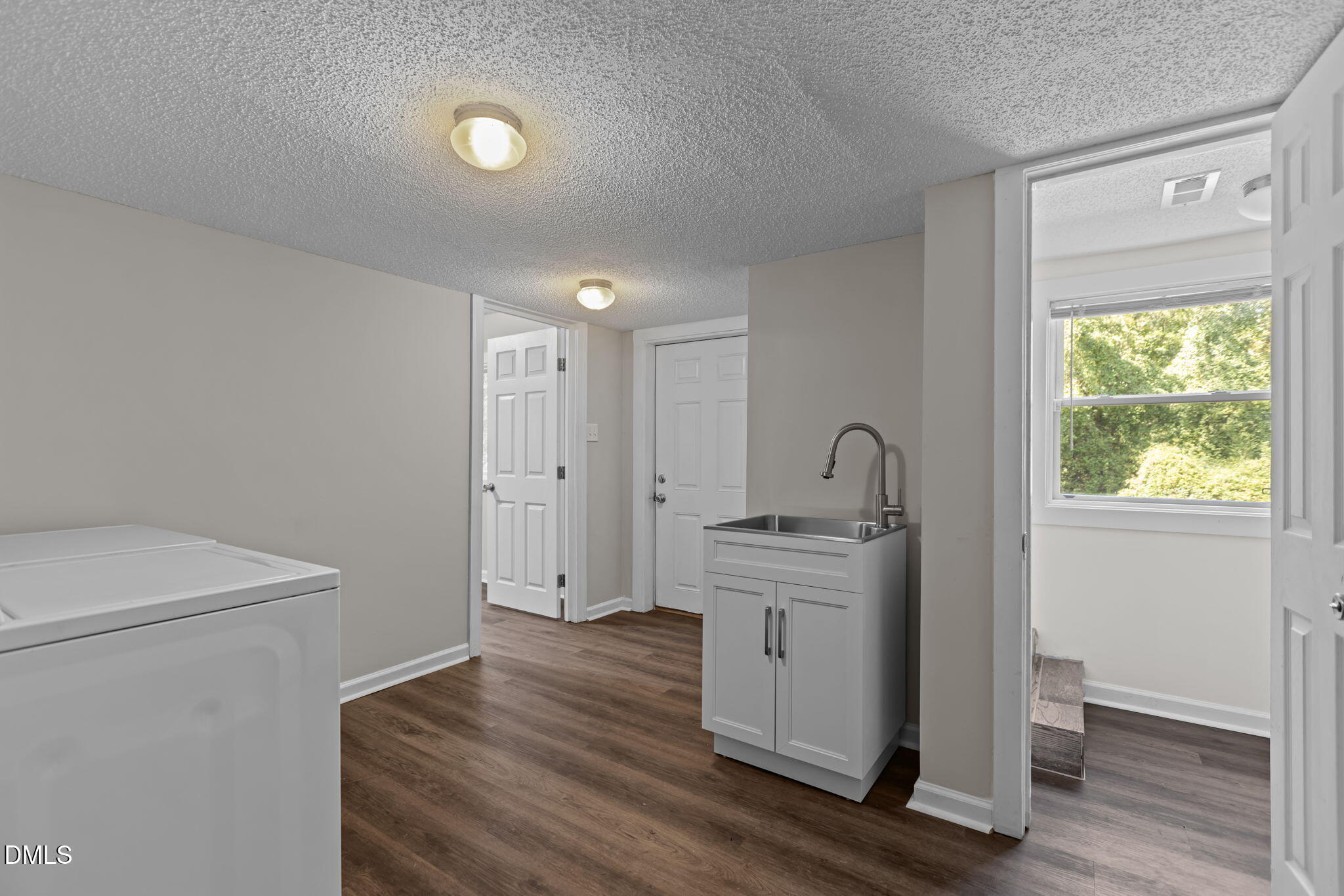 3117 Edgetone Drive Raleigh, NC 27604 - Photo 33 of 50 a view of an empty room with wooden floor a sink and a window