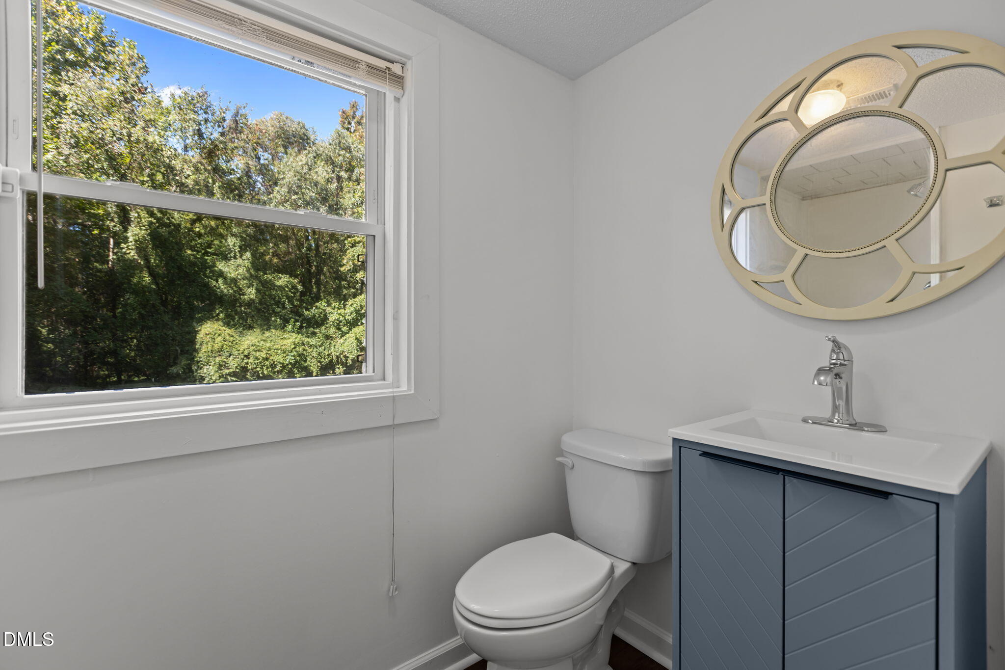3117 Edgetone Drive Raleigh, NC 27604 - Photo 34 of 50 a bathroom with a toilet sink and mirror