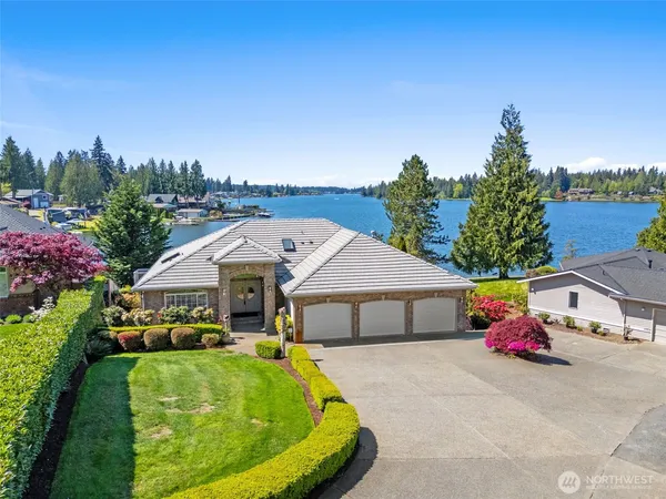 a aerial view of a house with swimming pool and yard