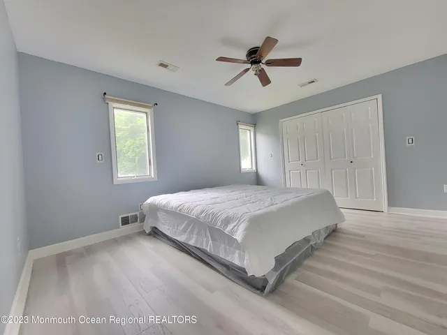 a spacious bedroom with a bed and a window
