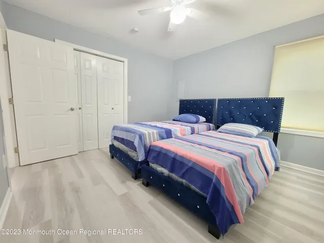 a spacious bedroom with a bed and a chandelier