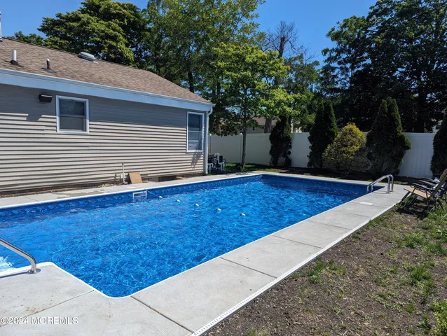 a view of a backyard with a large tree