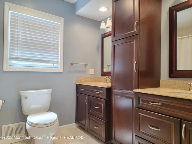 a bathroom with a toilet a sink and mirror