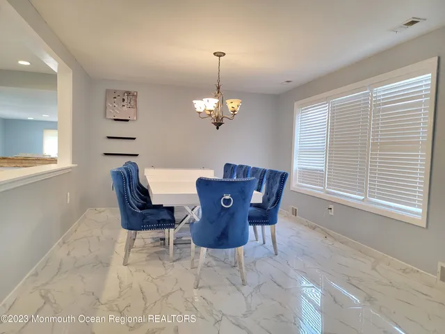 a dining room with furniture and window