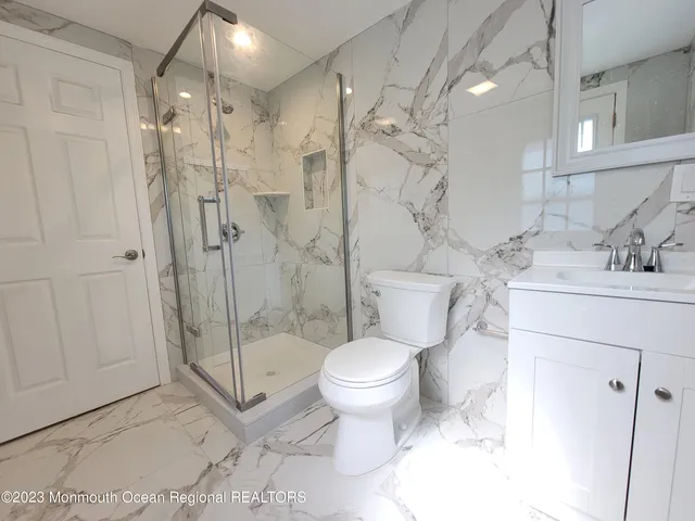 a bathroom with a sink toilet and shower