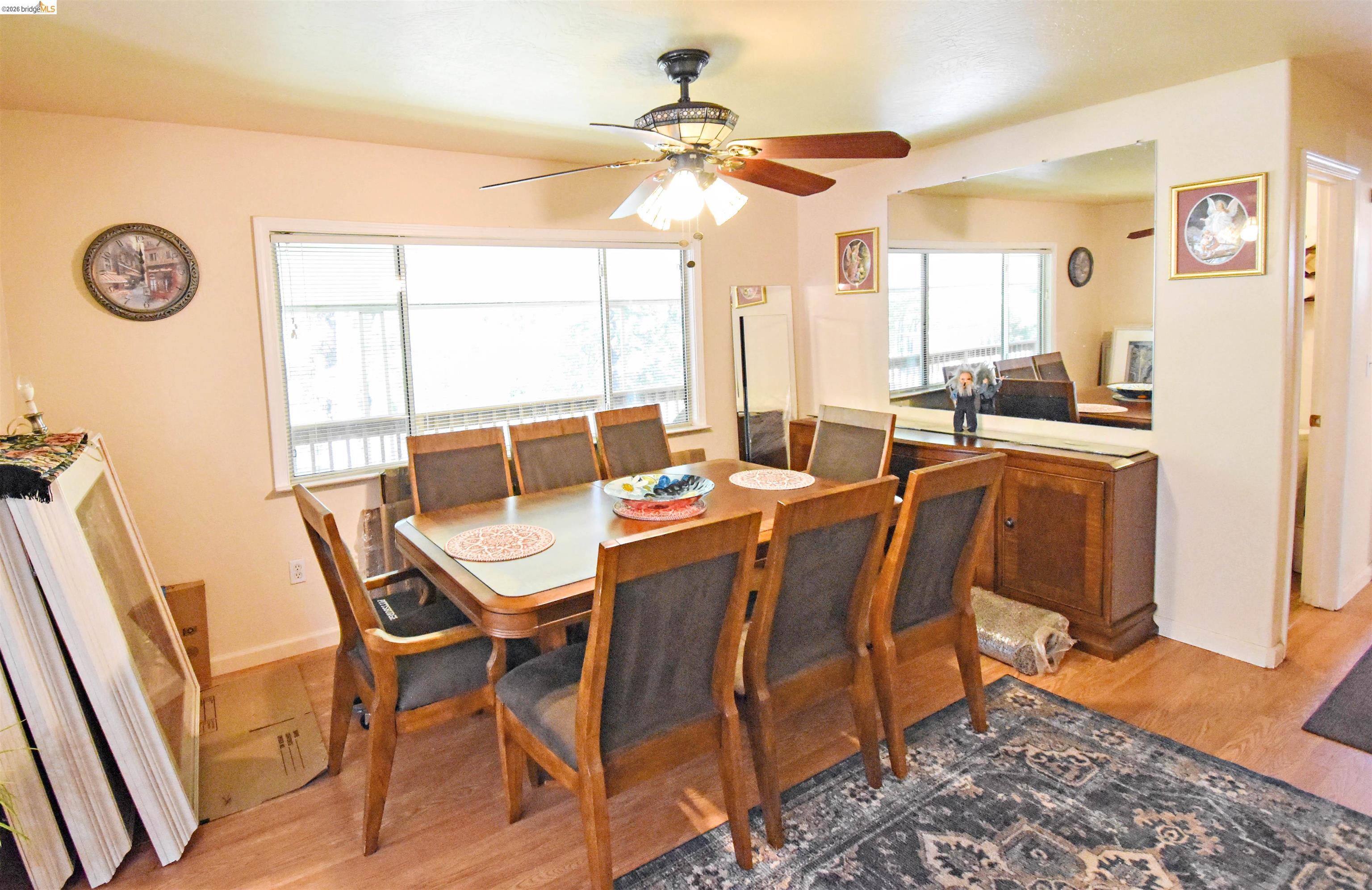 13904 Tuolumne Road Sonora, CA 95370 - Photo 21 of 44 Dining area featuring wood-finish flooring, a ceiling fan with integrated lighting, and a large window
