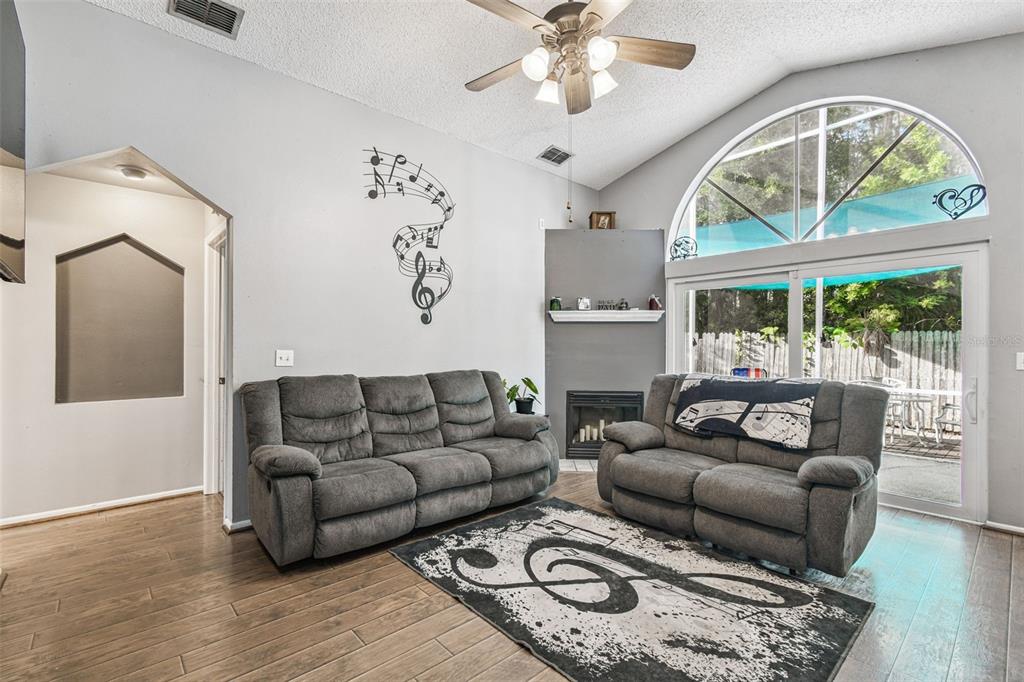 7501 Fawn Lake Road New Port Richey, FL 34655 - Photo 15 of 27 a living room with furniture a fireplace and a large window