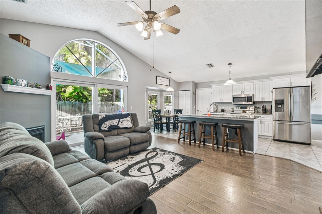 7501 Fawn Lake Road New Port Richey, FL 34655 - Photo 16 of 27 a living room with furniture a fireplace and a large window