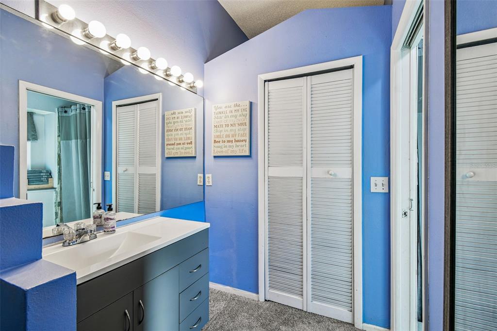 7501 Fawn Lake Road New Port Richey, FL 34655 - Photo 18 of 27 a bathroom with a double vanity sink a large mirror and a shower