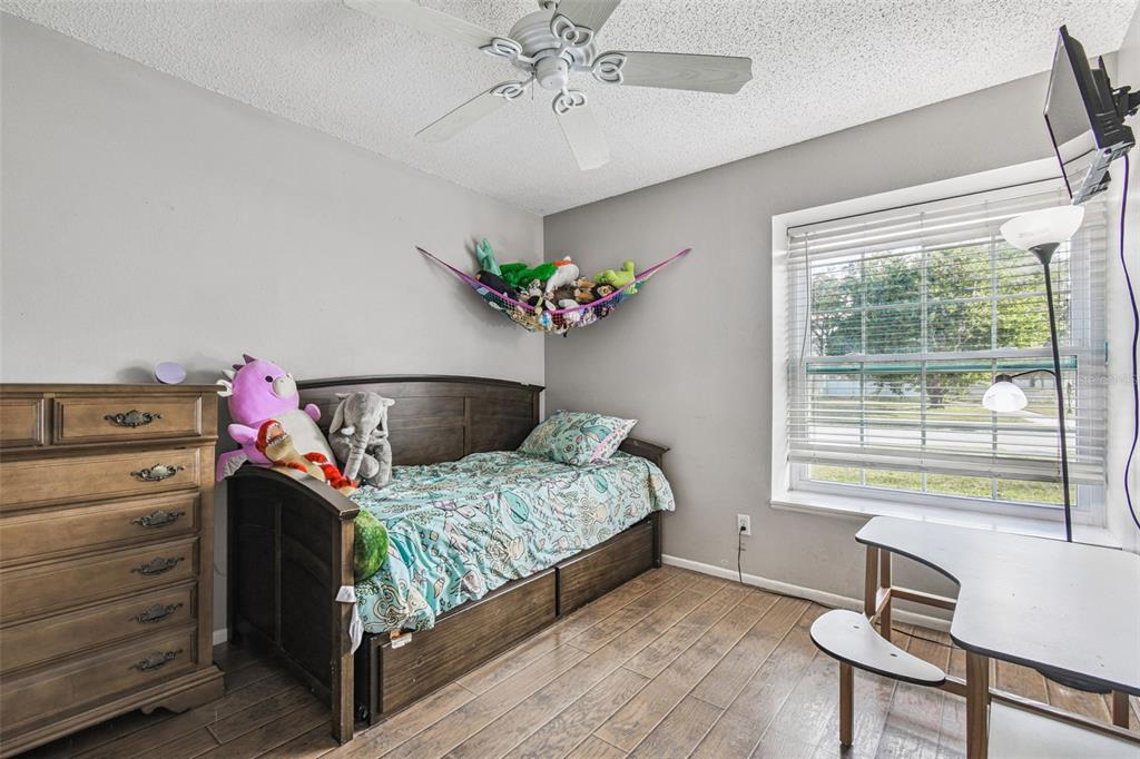 7501 Fawn Lake Road New Port Richey, FL 34655 - Photo 22 of 27 a bedroom with a bed and a chandelier