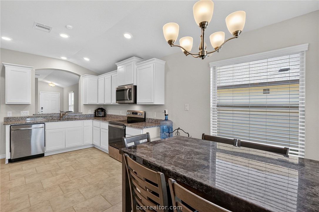 5235 Montague Loop Bryan, TX 77807 - Photo 10 of 25 a kitchen with a sink stainless steel appliances and cabinets