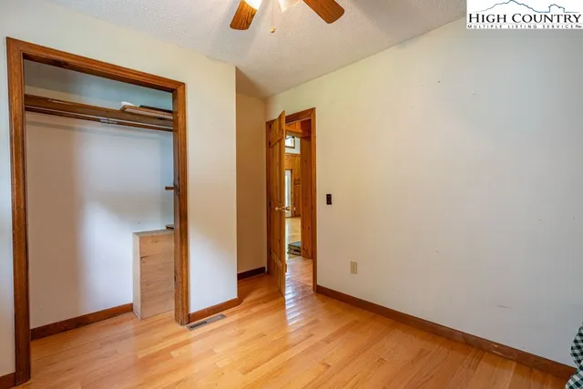 a view of a livingroom with a ceiling fan & window