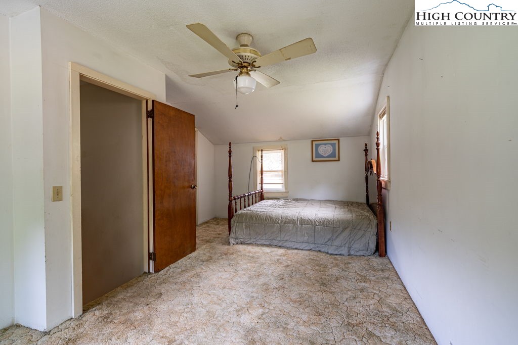 175 Roaring Fork Road Todd, NC 28684 - Photo 16 of 24 a view of a livingroom with a ceiling fan & window