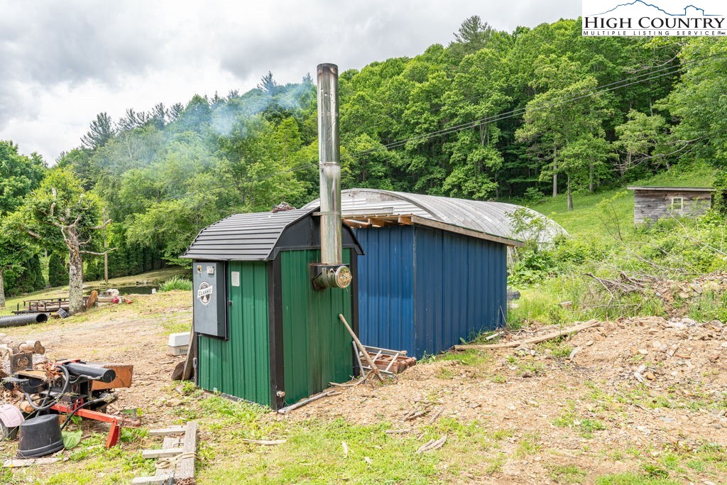175 Roaring Fork Road Todd, NC 28684 - Photo 17 of 24 a backyard of a house with lots of green space