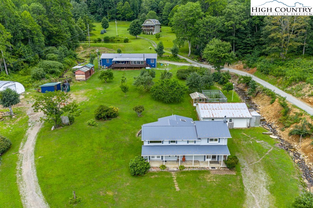 175 Roaring Fork Road Todd, NC 28684 - Photo 20 of 24 an aerial view of a house with garden space sitting space and swimming pool