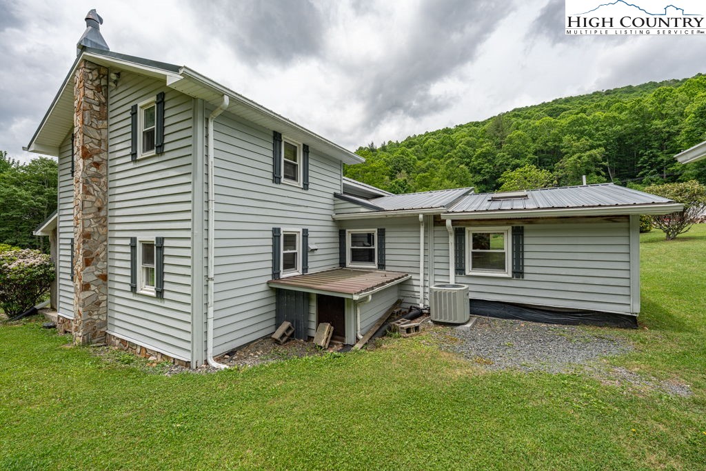 175 Roaring Fork Road Todd, NC 28684 - Photo 2 of 24 a backyard of a house with table and chairs
