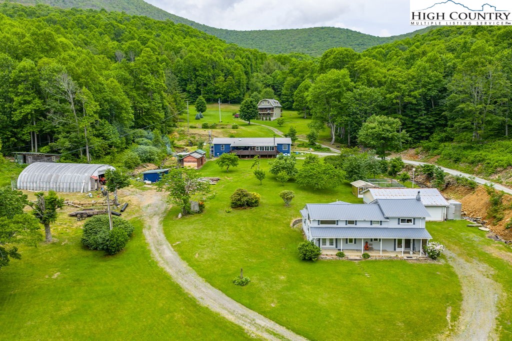 175 Roaring Fork Road Todd, NC 28684 - Photo 4 of 24 an aerial view of a house with a garden and houses
