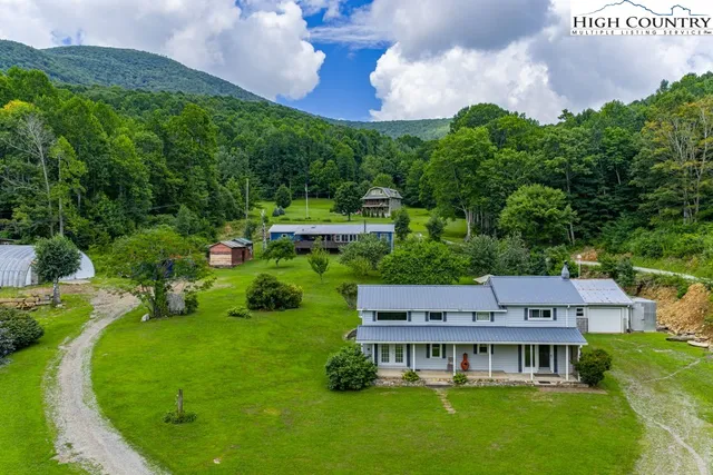 an aerial view of a house with a big yard