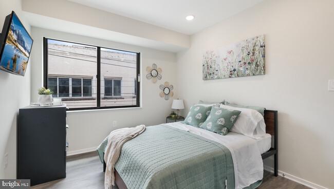 4415 Chestnut Street, Unit 206 Philadelphia, PA 19104 - Photo 4 of 8 a bedroom with a bed and a window