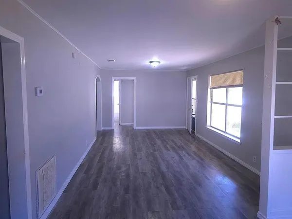 a view of hallway with wooden floor