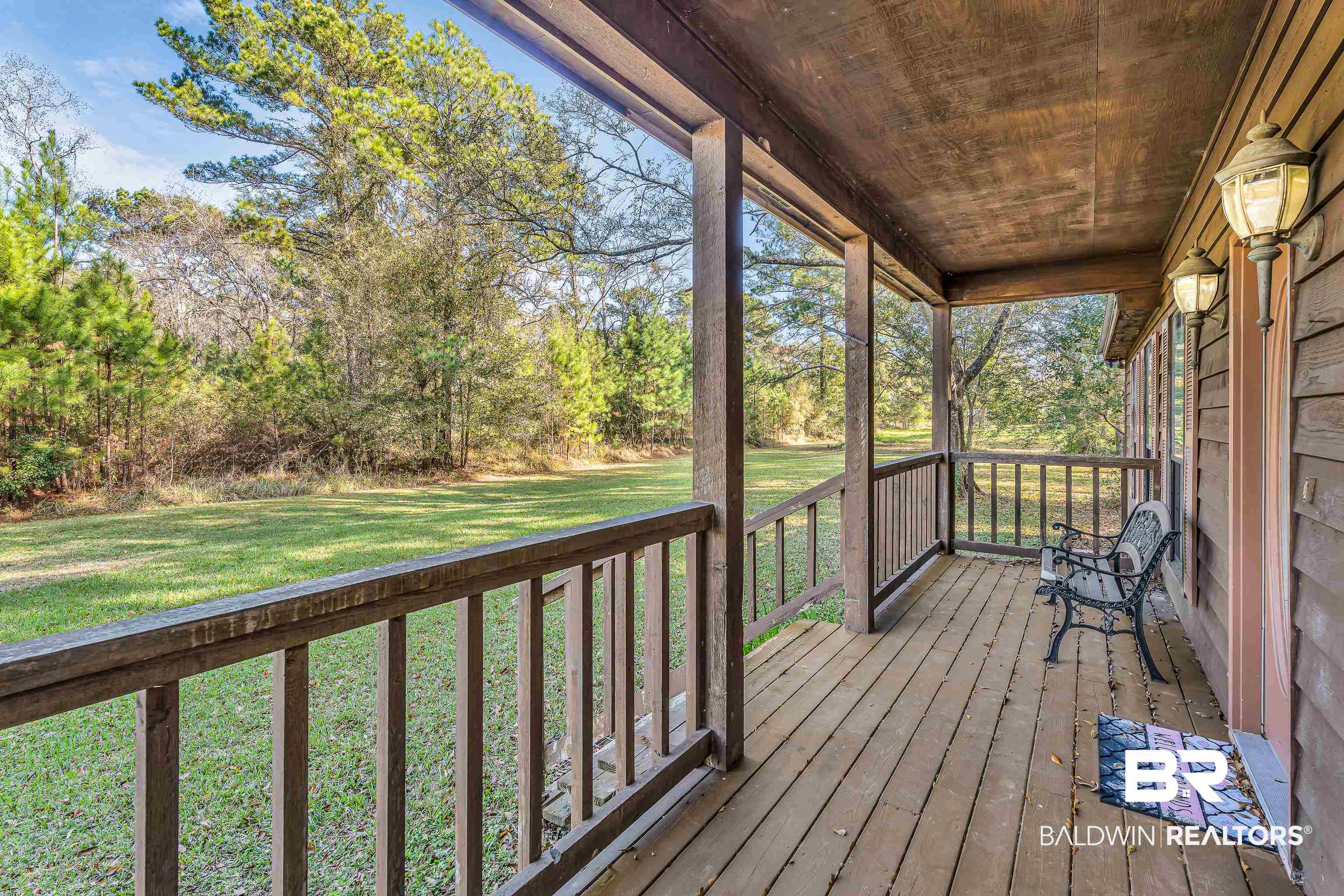 7787 Bellingrath Road Theodore, AL 36582 - Photo 11 of 36 Porch with a lawn and view of wooded area