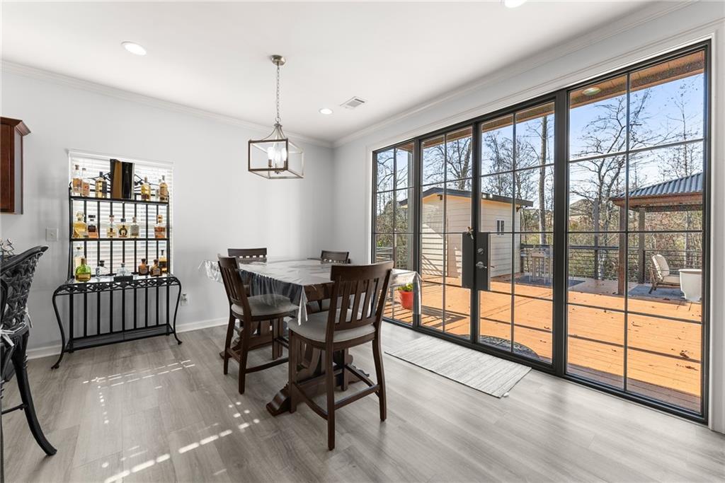 4302 Box Elder Path Gainesville, GA 30504 - Photo 15 of 53 a view of a dining room with furniture window and wooden floor