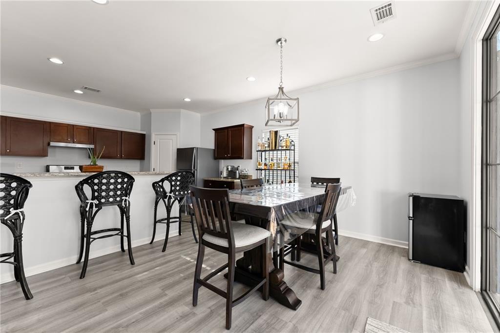 4302 Box Elder Path Gainesville, GA 30504 - Photo 16 of 53 a view of a dining room with furniture wooden floor and a chandelier