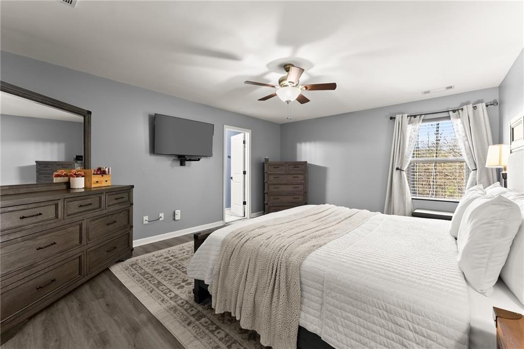 4302 Box Elder Path Gainesville, GA 30504 - Photo 18 of 53 a spacious bedroom with a bed and a flat screen tv