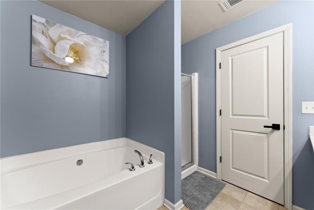 4302 Box Elder Path Gainesville, GA 30504 - Photo 22 of 53 a bathroom with a bathtub and shower