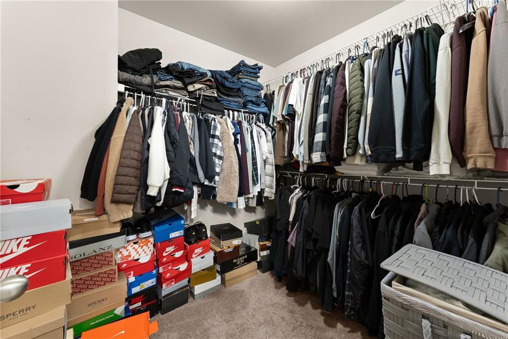4302 Box Elder Path Gainesville, GA 30504 - Photo 23 of 53 a view of walk in closet with clothes and shoes