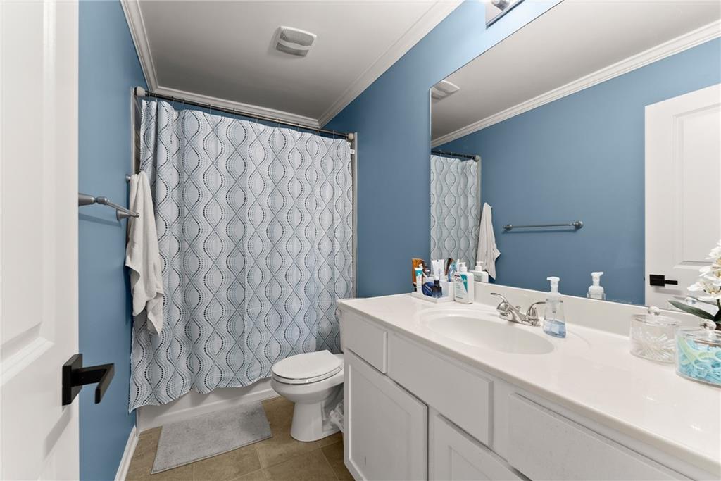 4302 Box Elder Path Gainesville, GA 30504 - Photo 31 of 53 a bathroom with a sink a toilet and shower curtain