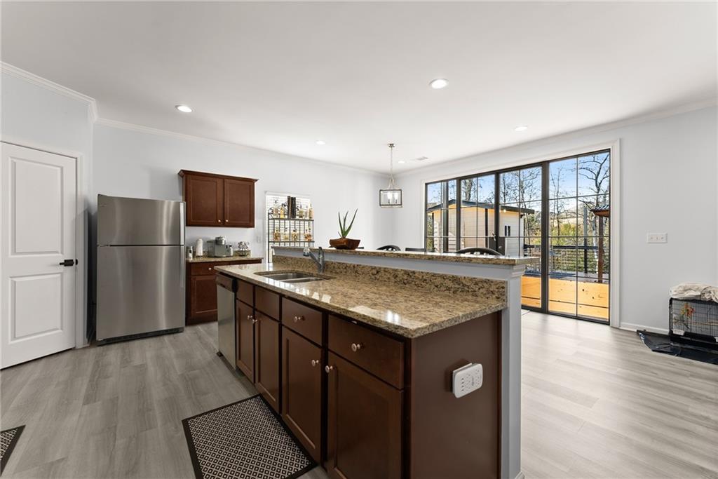 4302 Box Elder Path Gainesville, GA 30504 - Photo 10 of 53 a kitchen with stainless steel appliances granite countertop a refrigerator a stove and a wooden floors