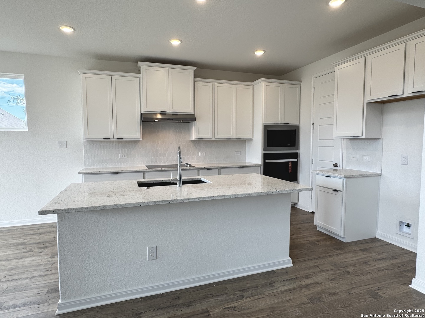 165 Annette Drive Castroville, TX 78009 - Photo 2 of 11 a kitchen with kitchen island a sink stainless steel appliances and cabinets