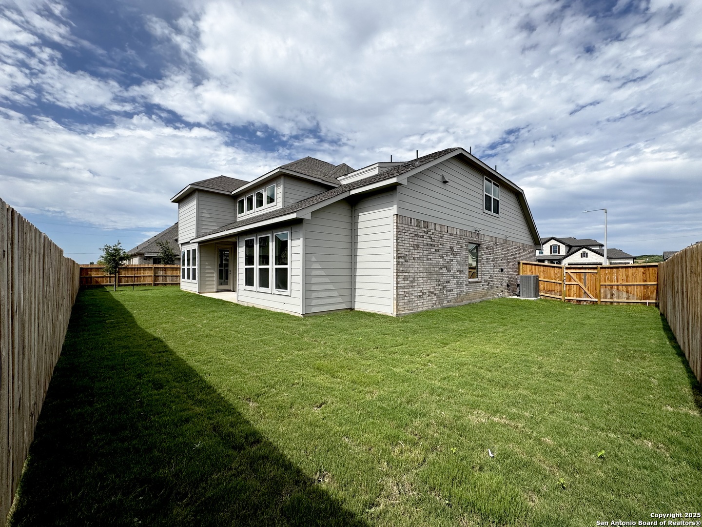 165 Annette Drive Castroville, TX 78009 - Photo 4 of 11 a front view of a house with a garden