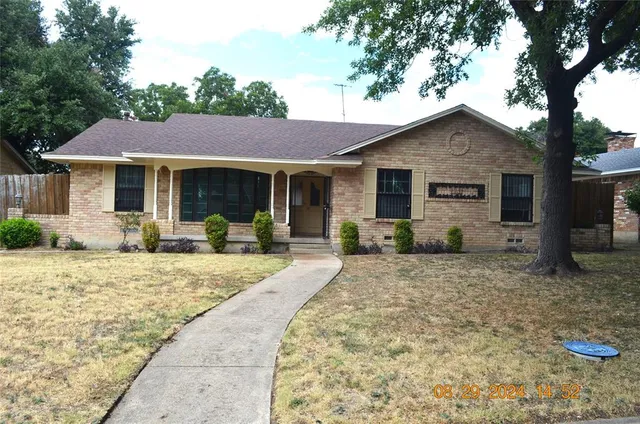 a front view of house with yard outdoor seating and barbeque oven