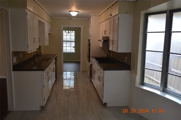 a kitchen with a refrigerator and a stove