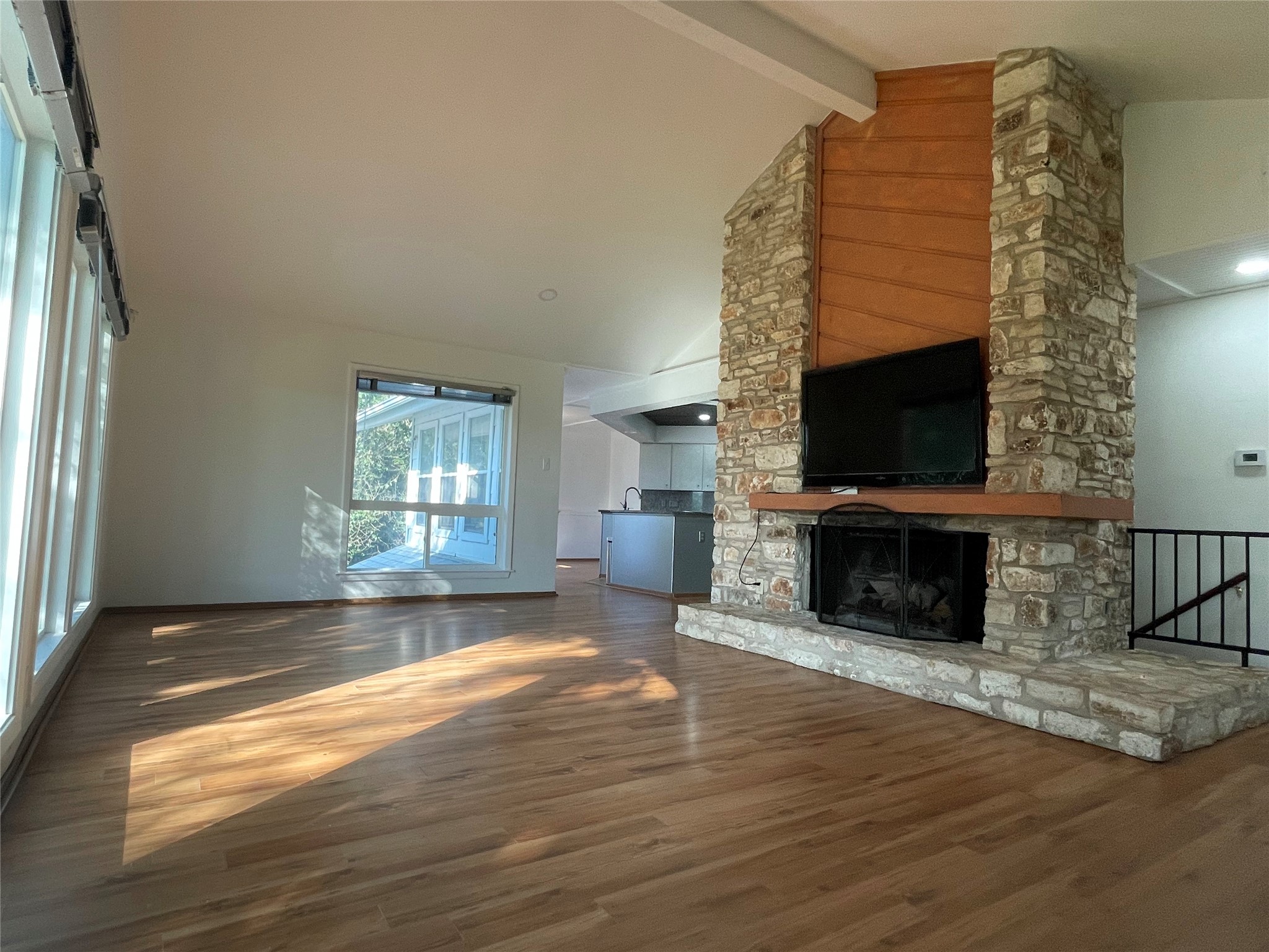 5802 Longhorn Landing Austin, TX 78734 - Photo 14 of 38 Unfurnished living room featuring a stone fireplace and wood finished floors