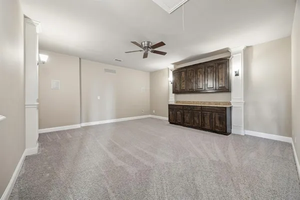 a view of an empty room with a kitchen