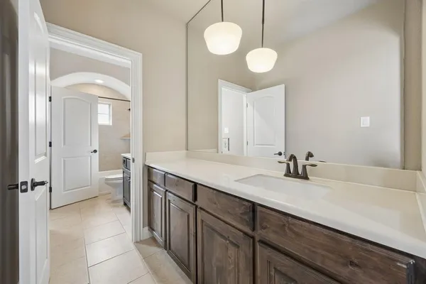 a bathroom with a sink vanity and a mirror