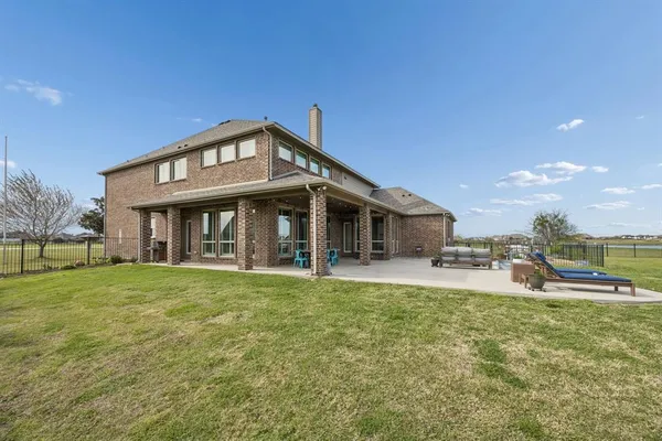 a view of a house with a yard and sitting area