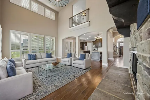 a living room with fireplace furniture and a floor to ceiling window