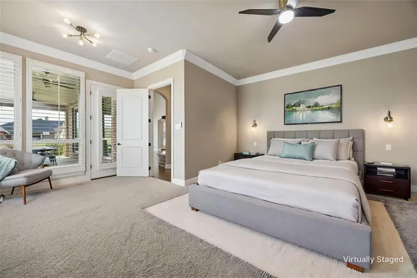 a spacious bedroom with a large bed and a chandelier