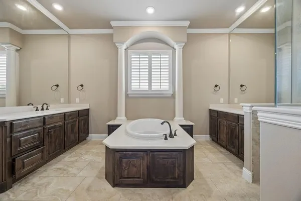 a spacious bathroom with a sink double vanity and a bathtub