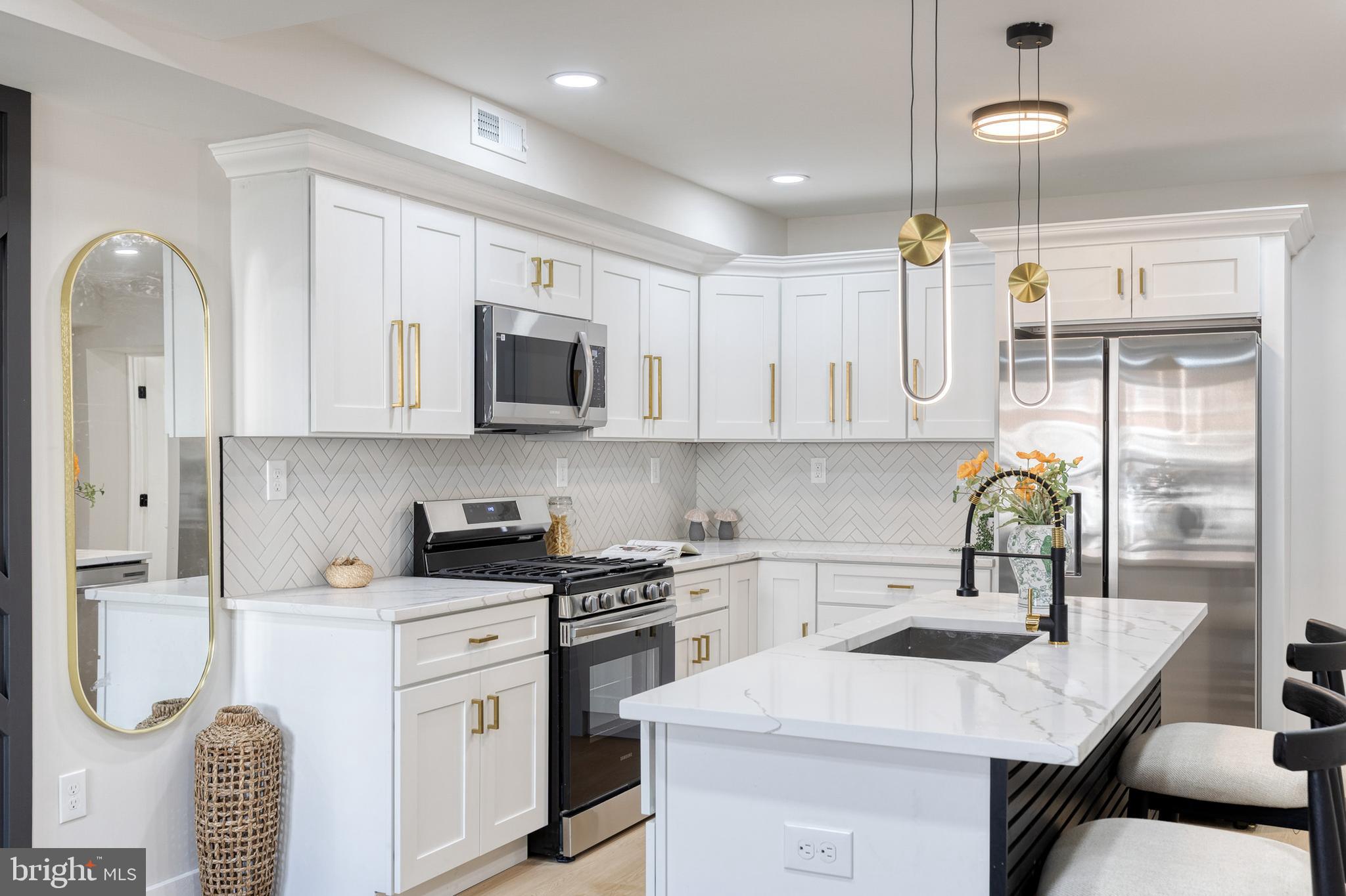 3721 Manchester Avenue Baltimore, MD 21215 - Photo 11 of 36 a kitchen with stainless steel appliances kitchen island granite countertop a sink a stove and cabinets