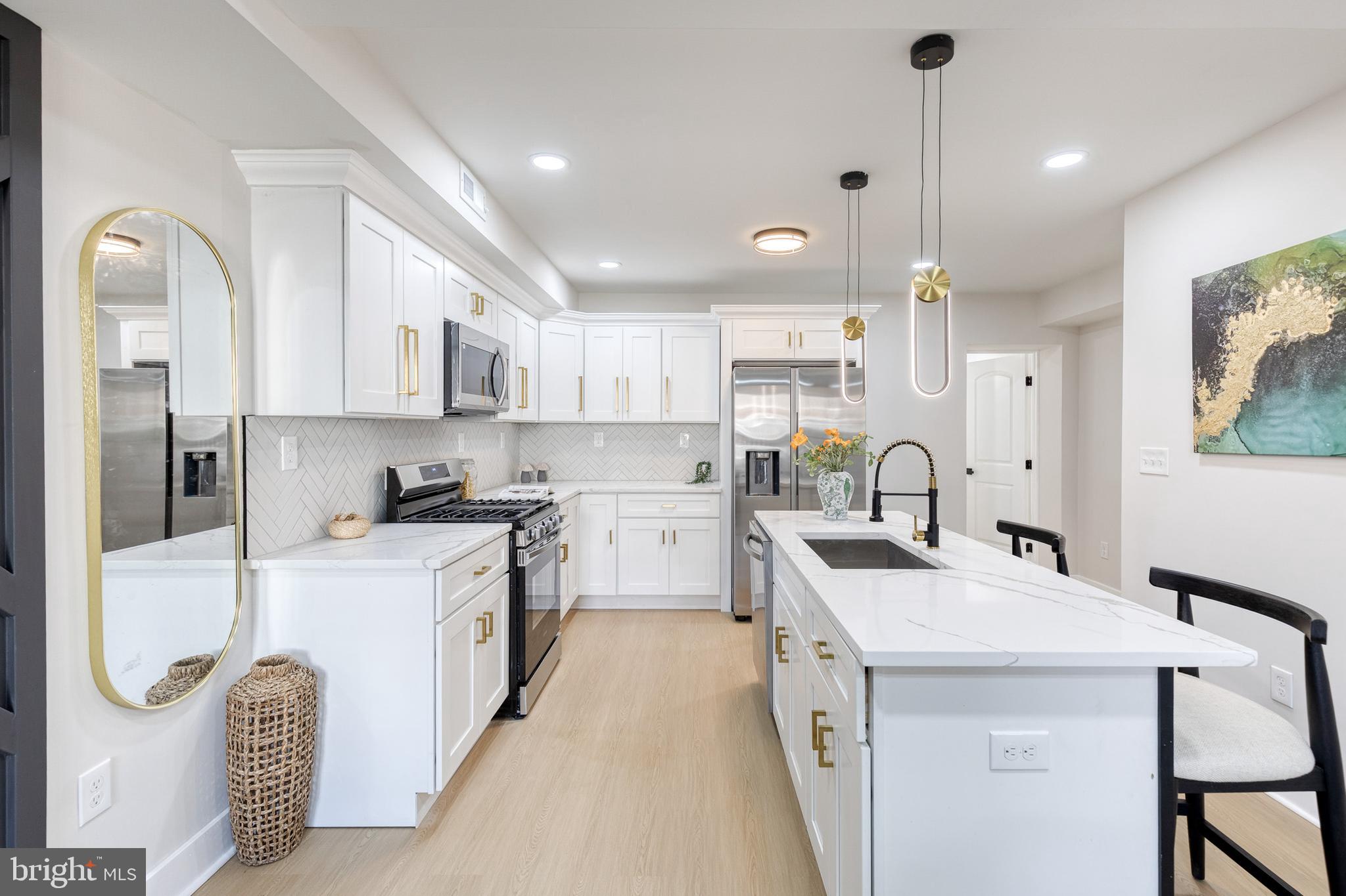 3721 Manchester Avenue Baltimore, MD 21215 - Photo 13 of 36 a kitchen with white cabinets and refrigerator