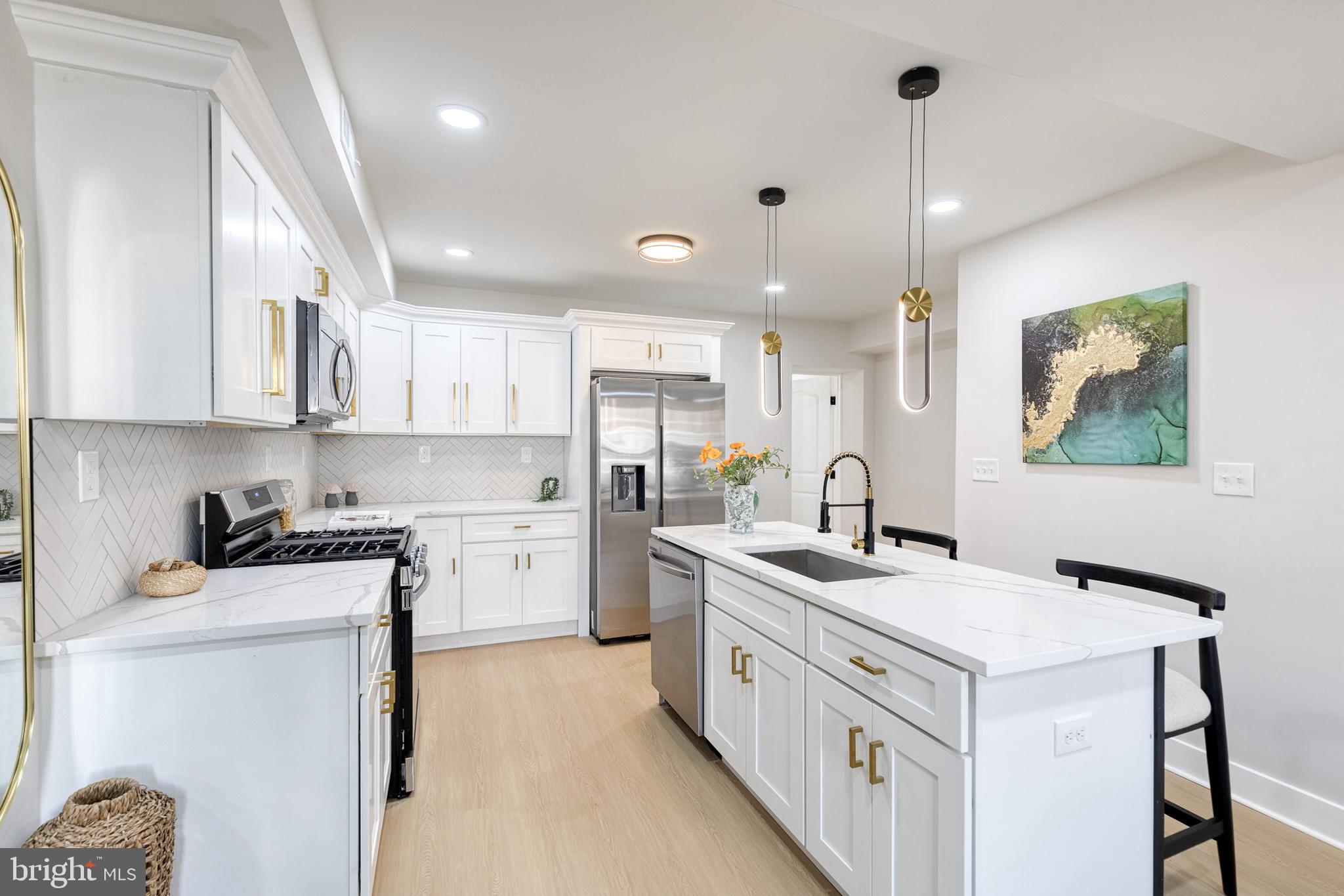 3721 Manchester Avenue Baltimore, MD 21215 - Photo 14 of 36 a kitchen with a sink stove and cabinets